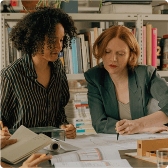 Two people reviewing written plans